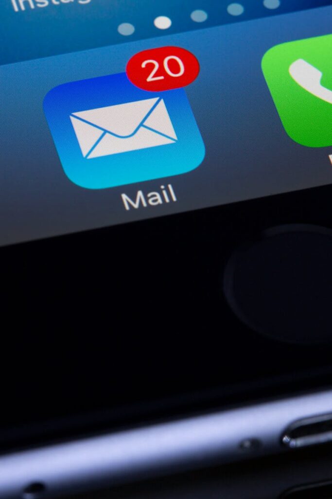 A close-up photo of a smartphone displaying popular apps like Google and Mail.